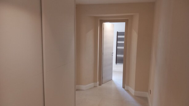 A hallway with a door leading to a room with a radiator. - Lina romantic apartment Vallombrosa wifi nature (Toscana)