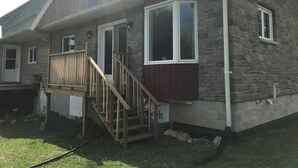 A single-story house with a front porch, a stone exterior, and a small deck. - Rest for your soul
Peace
Quiet
Nature
Secluded
Cozy


 (Lanark)