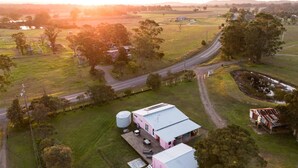 A rural property with a large house, a barn, and a road. - Heart of Lovedale (Keinbah)