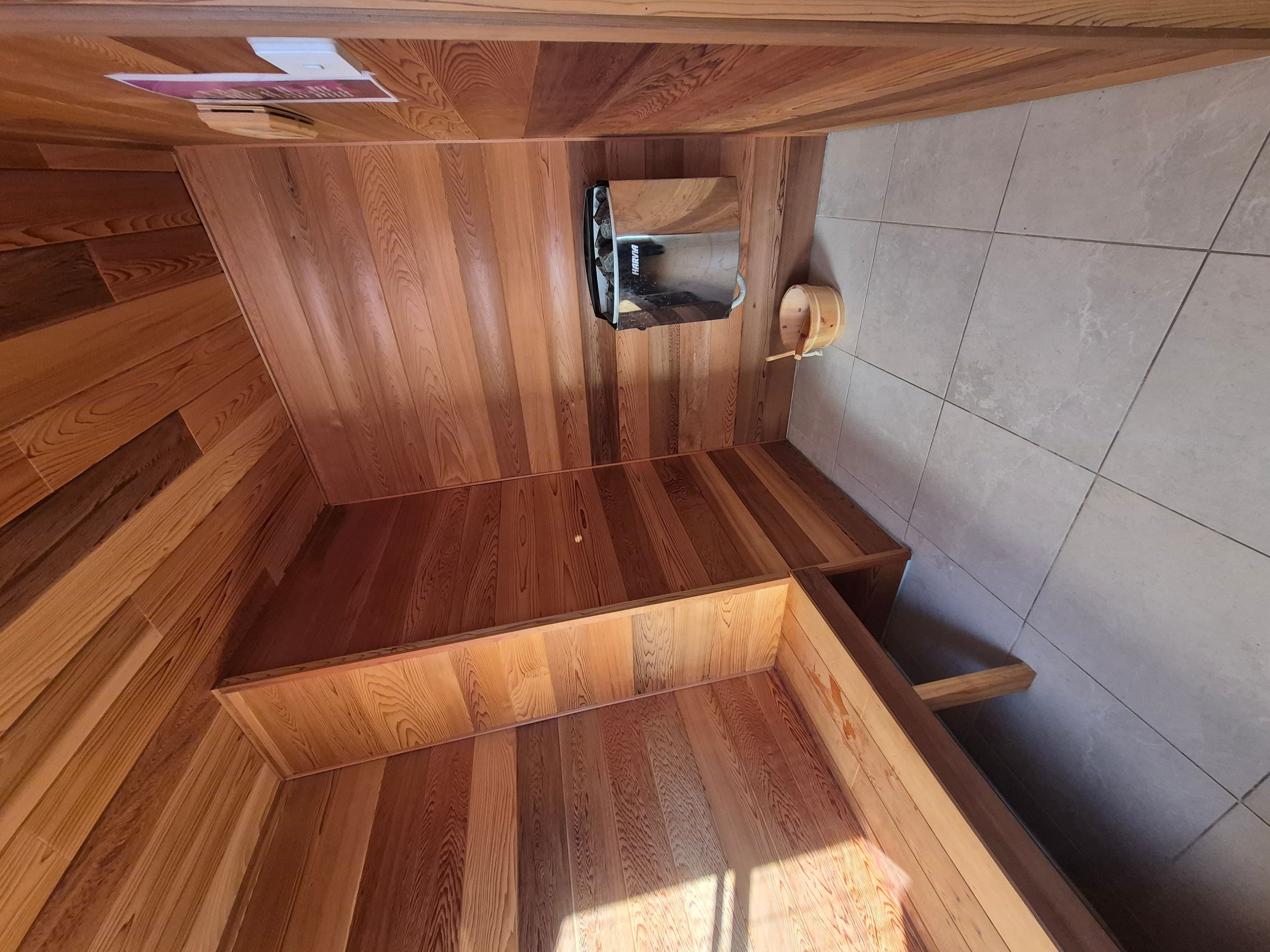 A wooden interior with a built-in bench and a small shelf.