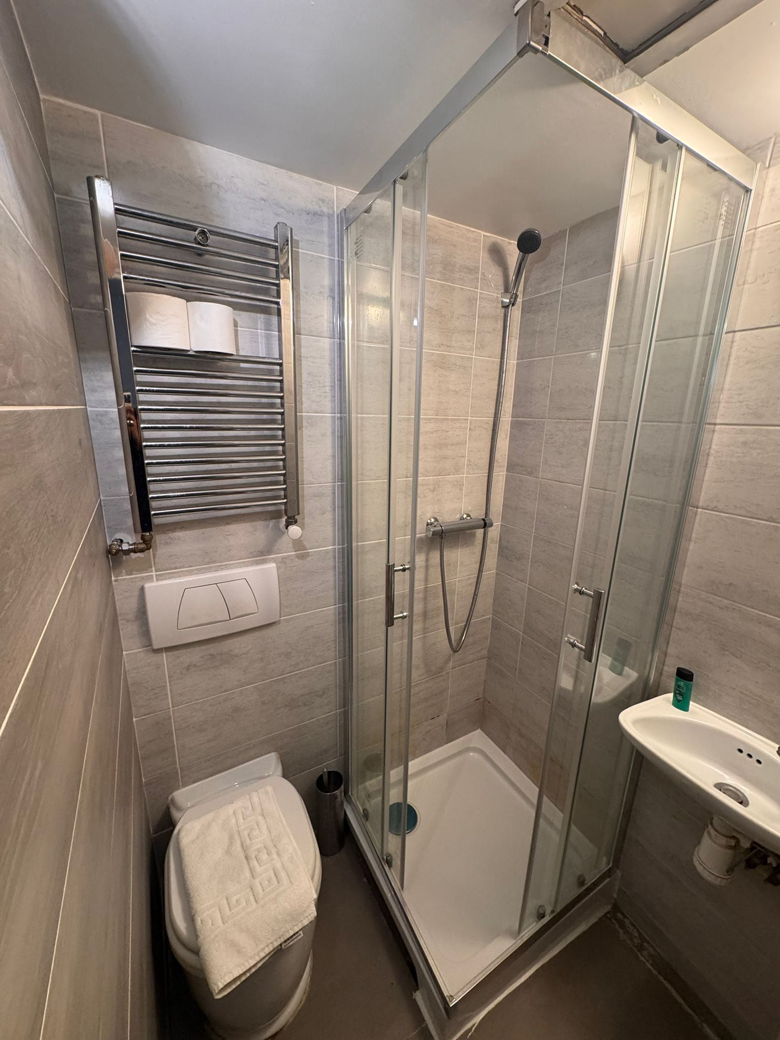 Ein modernes Badezimmer mit einer Duschkabine, einer Toilette und einem Waschbecken.