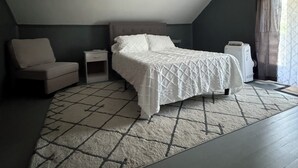 A bedroom with a bed, a chair, a nightstand, and a ceiling fan. - Walk Anywhere PSU! 3BR home in College Heights.  Summer discount now! (State College)