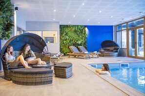 Relax by the pool with comfortable lounge chairs and sun loungers.