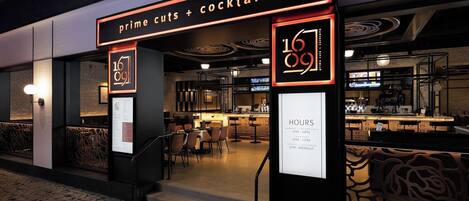 A restaurant with a modern interior, featuring a bar area and seating.