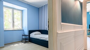 A room with a bed, a window, and a door leading to another room. - Via Nuova Marina 121 - Appartamento 1 (Naples)