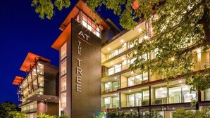 A multi-story hotel with a prominent sign reading "AT THE TREE."