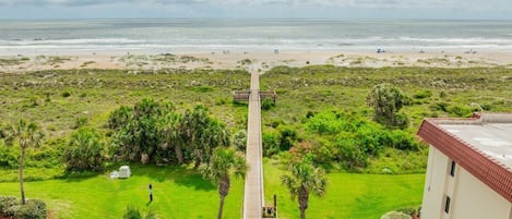 Ein Weg, der zu einem Strand mit Blick auf das Meer führt.