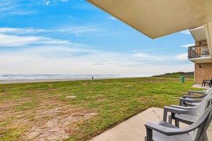 A beach view from a balcony with outdoor seating. - Gulfstream Condos Unit 115 | Gulf Front View | Beachfront Patio (Corpus Christi)