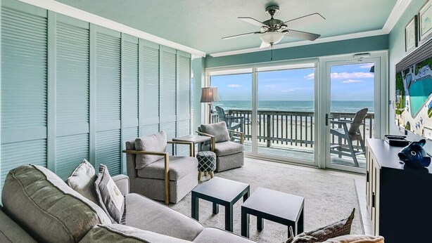 A cozy balcony with a view of the ocean, furnished with a sofa, chairs, and a small table. - Gulfstream Condos Unit 306 | Gulf Front Views & Balcony | Pool, Hot Tub (Corpus Christi)