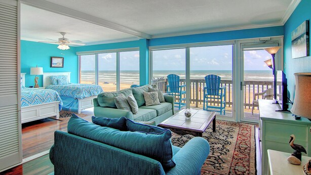 A spacious room with a large sliding glass door leading to a balcony overlooking the beach. - GSC Unit 512 | Pickleball, Pool, Hot Tub & BBQ | Beachfront View (Corpus Christi)
