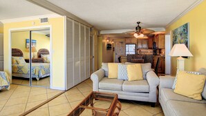 A living room with a sofa, a coffee table, and a dining area with a table and chairs. - Gulfstream Condos Double Unit | 2 Adjoining Beachfront Top-Floor Units (Corpus Christi)