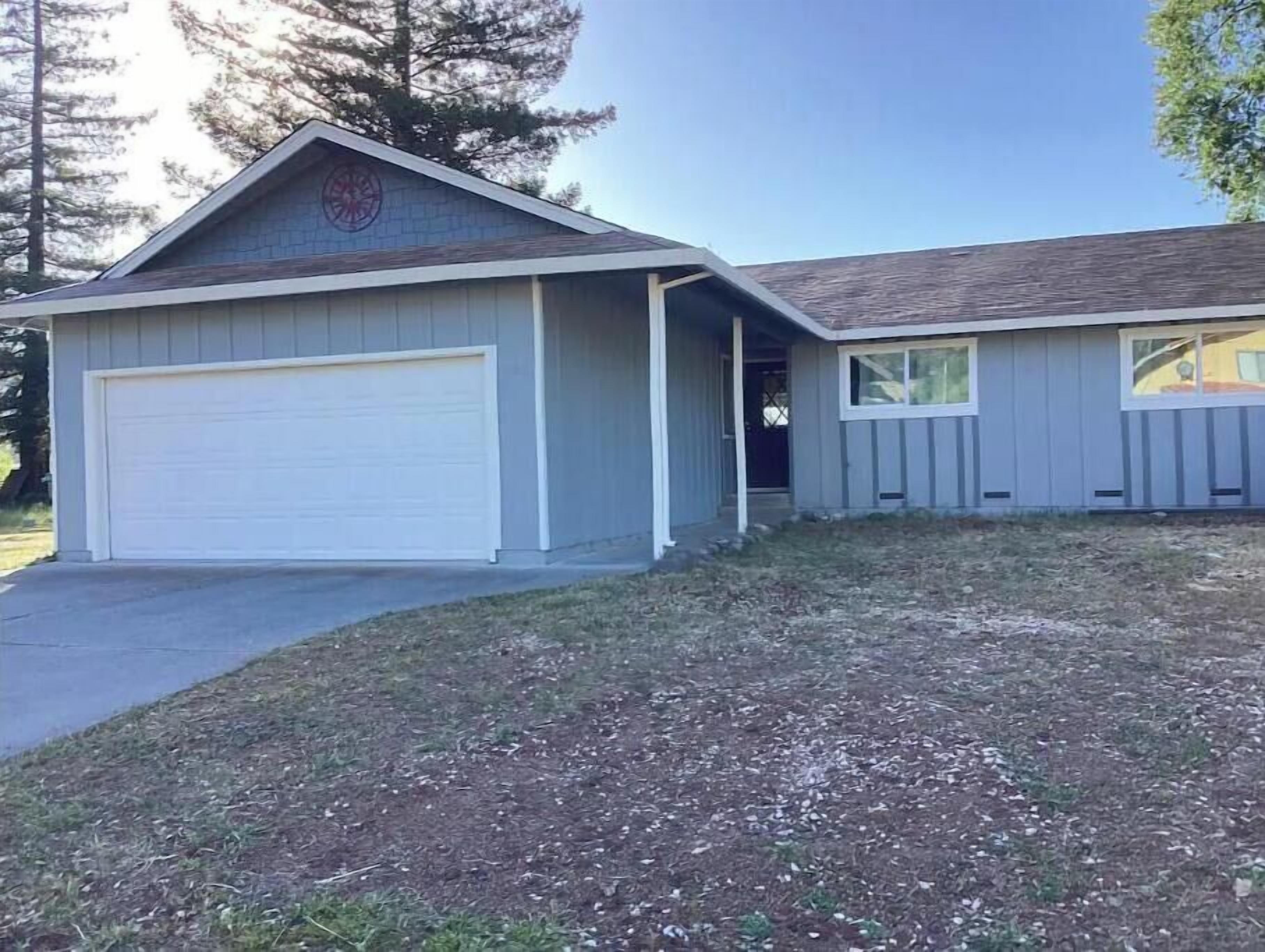 A single-story house with a garage and a small attached structure.