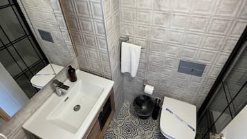 Shower, hair dryer, slippers, towels