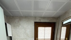 A bathroom with a toilet, sink, and window. - Lokal Ayvalık (Ayvalik)