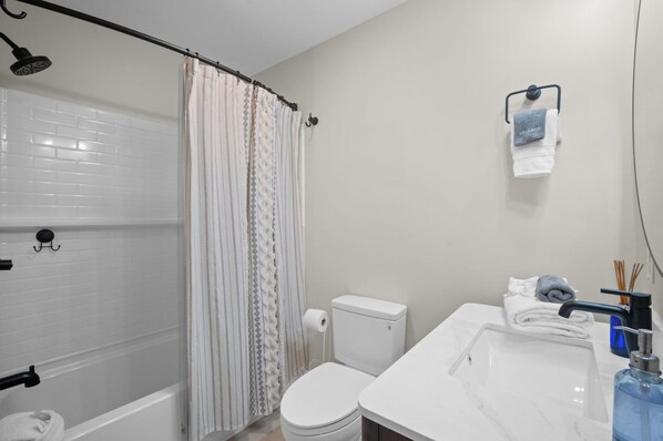 A bathroom with a shower, toilet, and sink. - Our Fripp Getaway, 6-Seat Golf Cart Included, Pets Considered, Neighborhood Pool, 239 Deerfield Court (Fripp Island)
