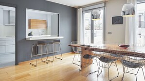 A modern kitchen with a white countertop, a wooden cabinet, and a large mirror. - Boulevard Terrace by FeelFree Rentals (Donostia)