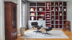 A modern living room with a wooden cabinet, a black office chair, a white rug, and a bookshelf filled with various items. - Boulevard Terrace by FeelFree Rentals (Donostia)