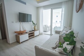 Deluxe Apartment, 2 Bedrooms, Balcony, Pool View | Living area | 43-inch flat-screen TV with cable channels