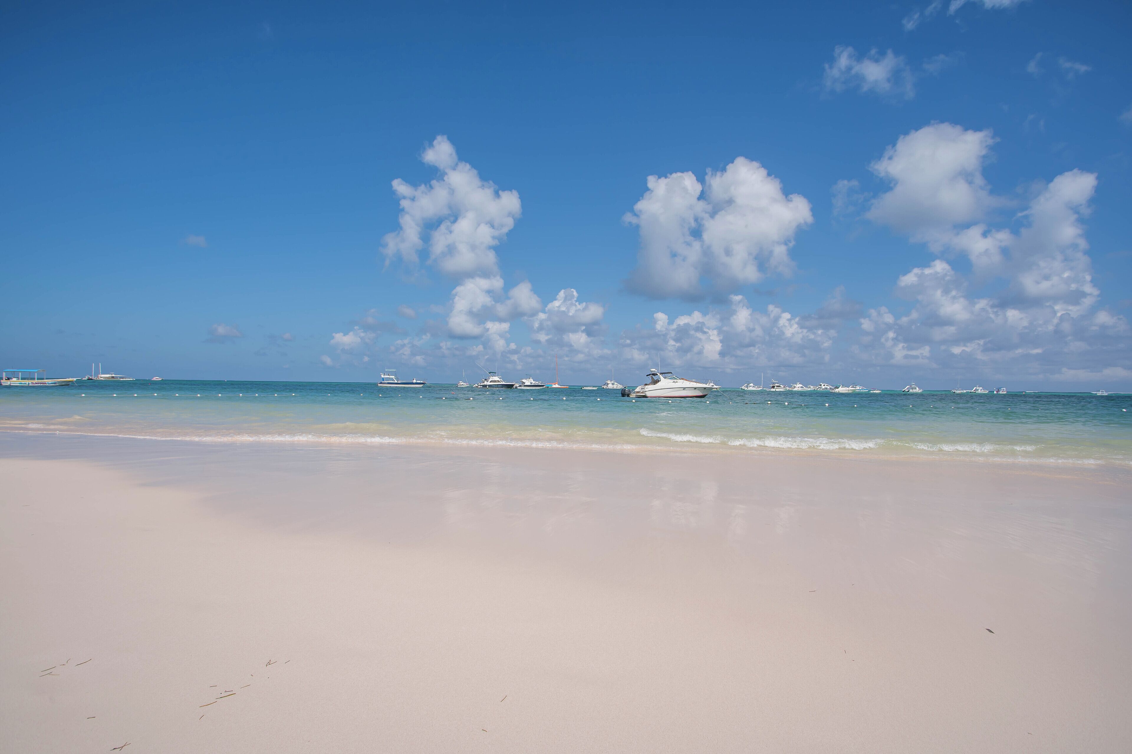 Uma praia com areia branca e águas calmas.