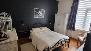 A bedroom with a bed, a white wardrobe, a birdcage, and a framed picture on the wall. - Room-terrace of the Friends of Visé (Vise)
