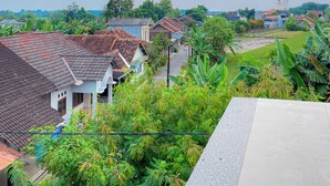 A residential area with houses, a road, and greenery. - d'WF Hotel (Kalasan)