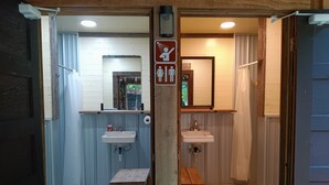 A small, rustic bathroom with a wooden bench, a sink, and a mirror. - Boho Off-grid Glamping at Honeysuckle Springs (Cosby)