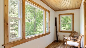 A room with large windows, wooden flooring, and a sloped ceiling. - Waterfront retreat with fireplace 3 miles from Whiteface & The North Pole (Wilmington)