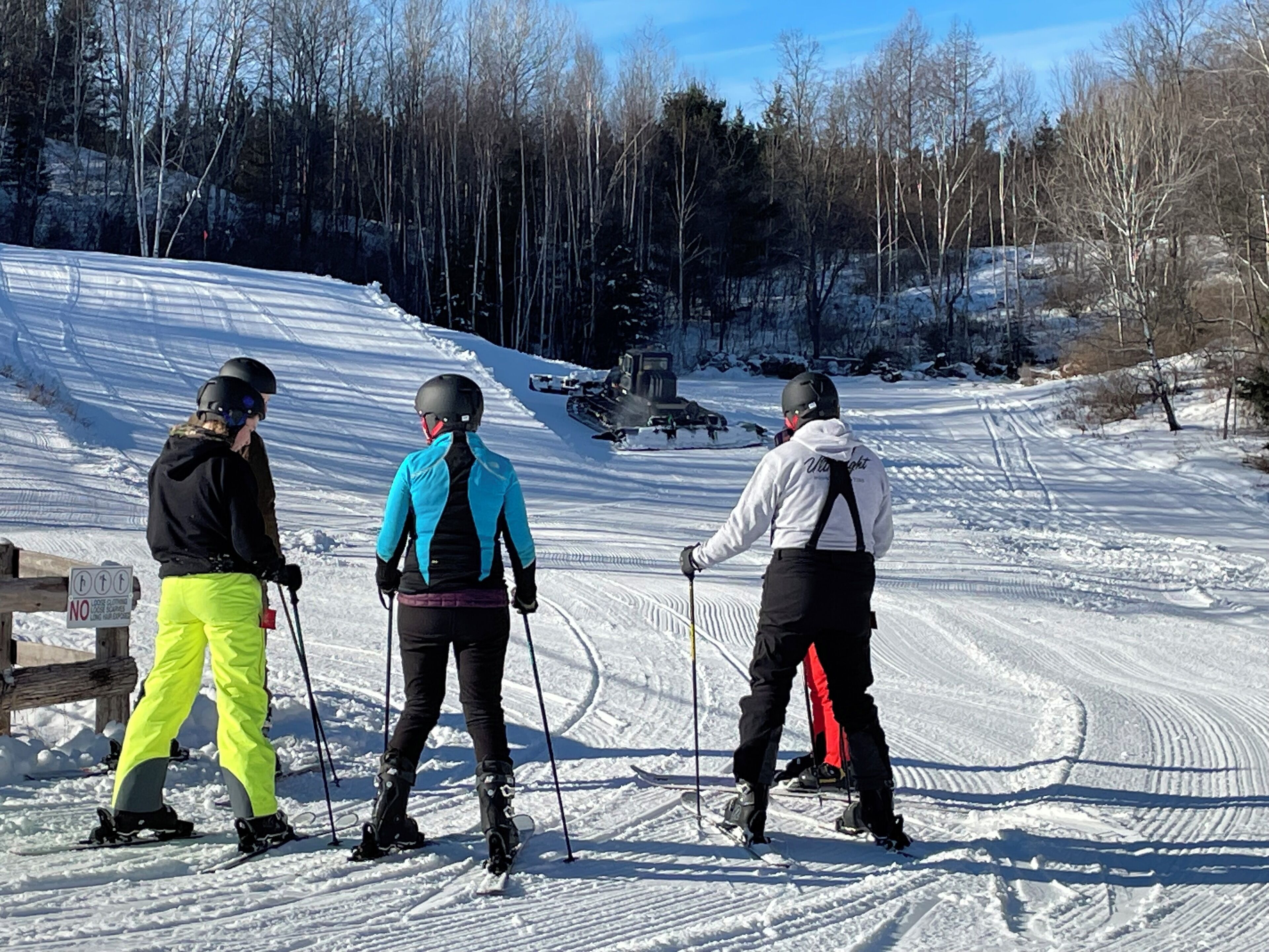 A snowy ski slope with skiers.