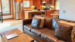 A modern kitchen with wooden cabinets, stainless steel appliances, and a central island. - Koblegarde's Beach House-Unwind and recharge-Fireplace & Cozy Vibes-Peaceful (Cannon Beach)