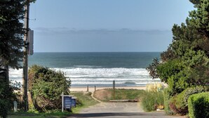 A coastal road leading to a beach with a clear view of the ocean. - Sand Pads - Ocean View- Sunset Views-Guest Favorite-Ideal For Families- (Cannon Beach)