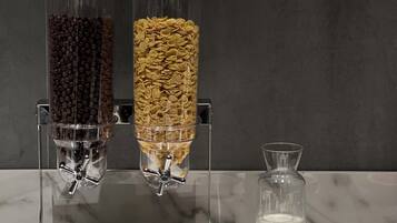 A breakfast buffet with various food options and a milk dispenser.