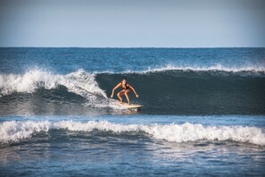 A person surfing on a wave in the ocean. - El MURO MAJAHUA RETREAT CENTER (Troncones)
