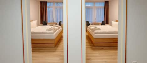 Family Room, City View | Premium bedding, blackout drapes, iron/ironing board, travel crib