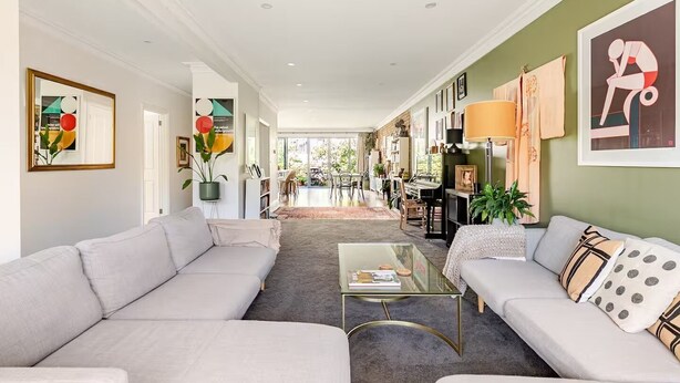 A spacious living area with a sofa, coffee table, and a dining area in the background. - Spacious Bayside Elwood Home. Walk to the beach, the botanical gardens, cafes.. (Elwood)