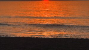 A sunset over a calm sea with a clear horizon. - Stylish Seaside Serenity with Pool Jersey Shore - Heart-Shaped Tub & Sunroom (Seaside Heights)