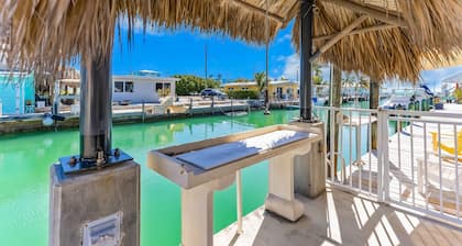 Custom canal-front home with private pool, palapa hut, & outdoor kitchen