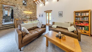 A rustic interior with stone walls, wooden beams, a bar area, and a bookshelf. - 2 bedroom accommodation in Southgate, near Aberystwyth (Southgate, near Aberystwyth)