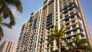 A high-rise residential building with multiple balconies and a modern architectural design. - Modern building, centrally-located condo,2 bedrooms/2 bathrooms, parking space.  (Doral)