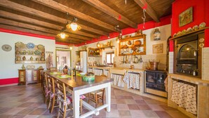 A kitchen with wooden beams, a central island, and a vintage oven. - Awesome home in Palazzo Adriano (Palazzo Adriano)