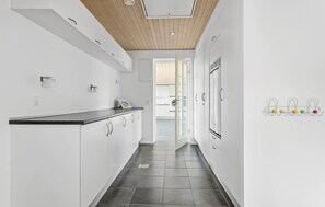 A modern kitchen with white cabinetry, a dark countertop, and a wooden ceiling. - Amazing home in Vesløs with WiFi (Vesløs)