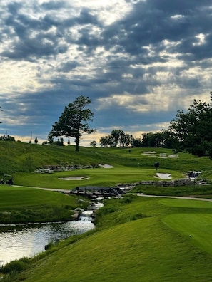 A golf course with a bridge over a stream, trees, and a cloudy sky. - Cove Castle at Monkey Island, Ok on Grand Lake
5 min to Shangri-La Golf Courses (Afton)