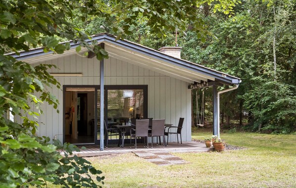 A small, single-story building with a covered patio area.