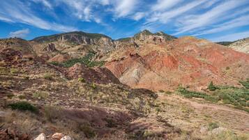 A rugged landscape with rocky terrain and sparse vegetation.