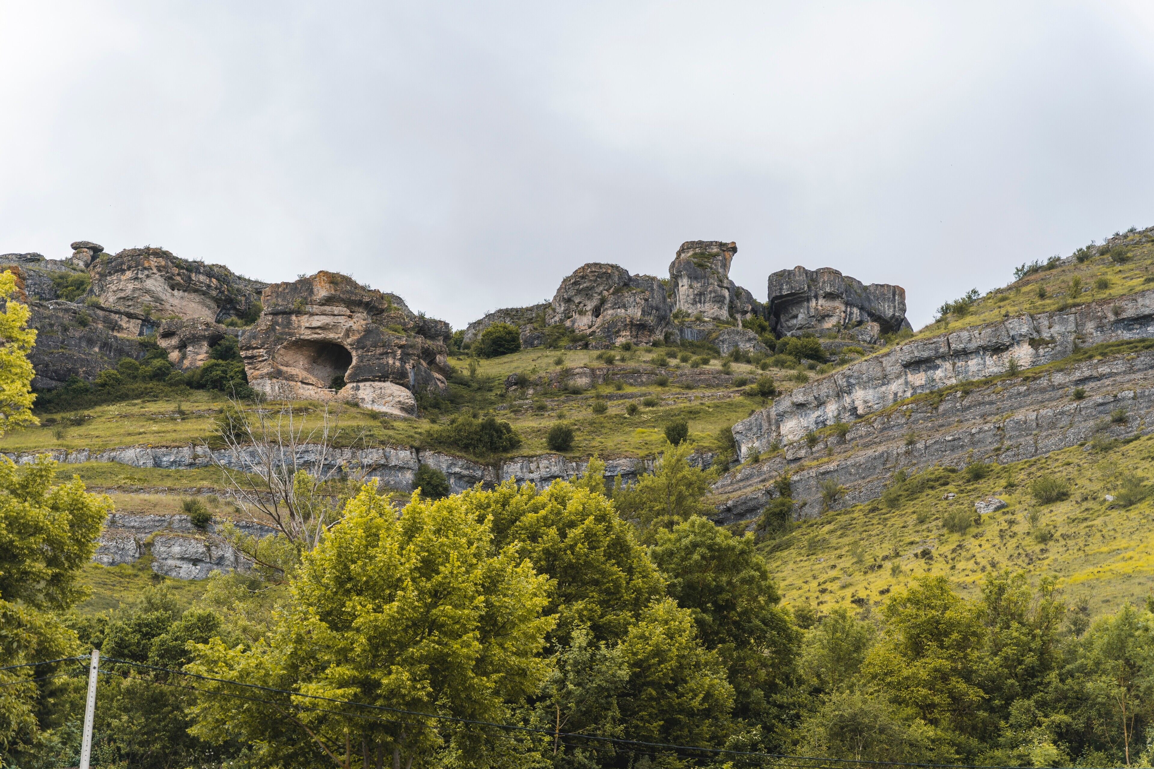 A mountainous landscape with rocky formations and greenery.