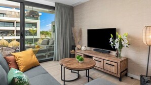 A modern living room with a flat-screen TV, a coffee table, a sofa, and a floor lamp. - Apartment 'Penthouse Santa Rosalia' with Private Pool, Wi-Fi and Air Conditioning (Santa Rosalia Torre Pacheco)