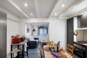 A compact living space with a kitchenette, dining area, and a small seating area.