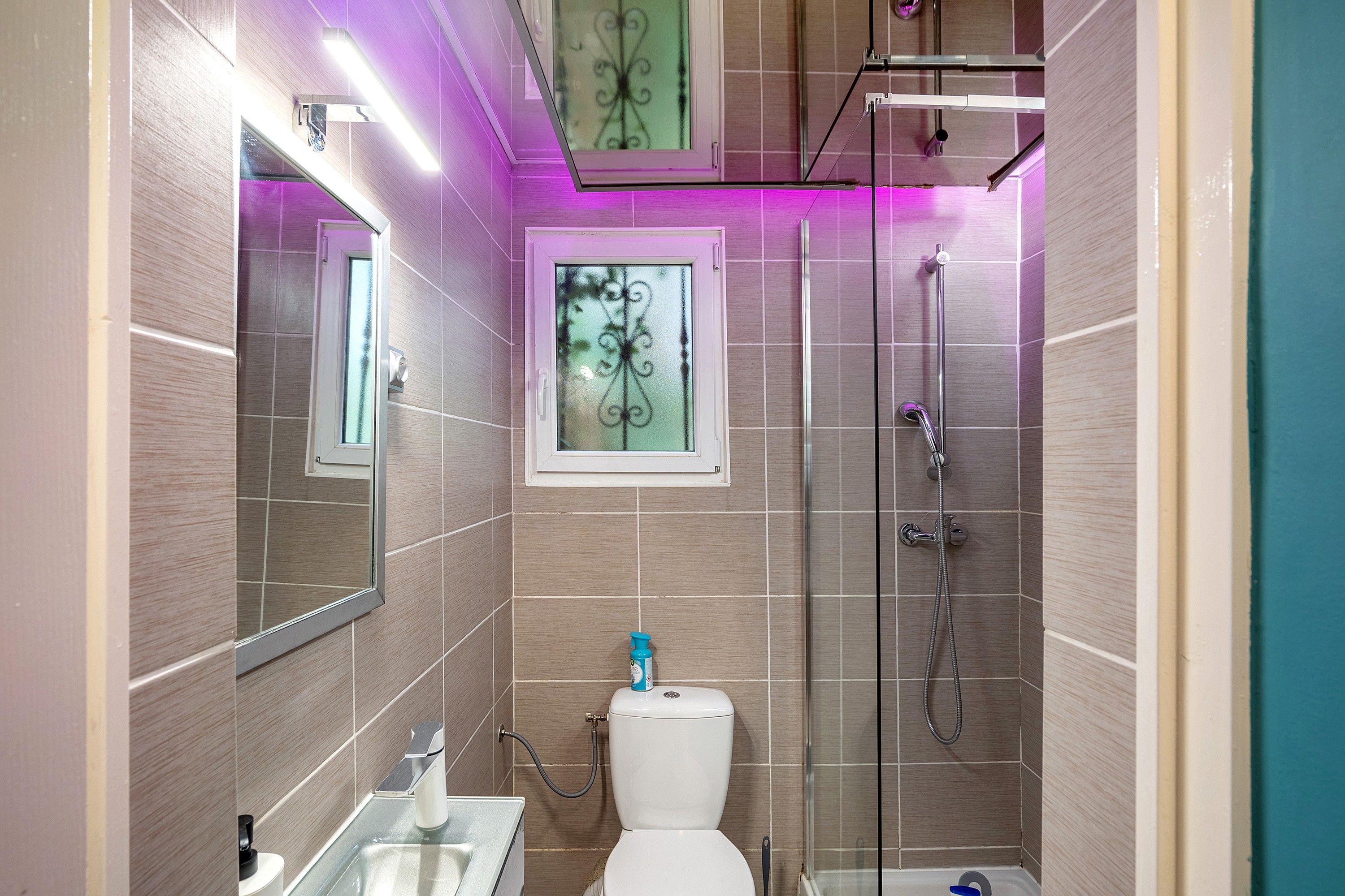 Ein modernes Badezimmer mit Duschkabine aus Glas, Toilette und Waschbecken.