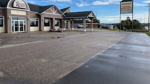 A building with a sign for Mac's Grill and a sign for Almac Hotel. - ALMAC HOTEL Lac La Biche (Lac La Biche)