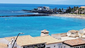 A coastal hotel with a view of the beach and ocean.
