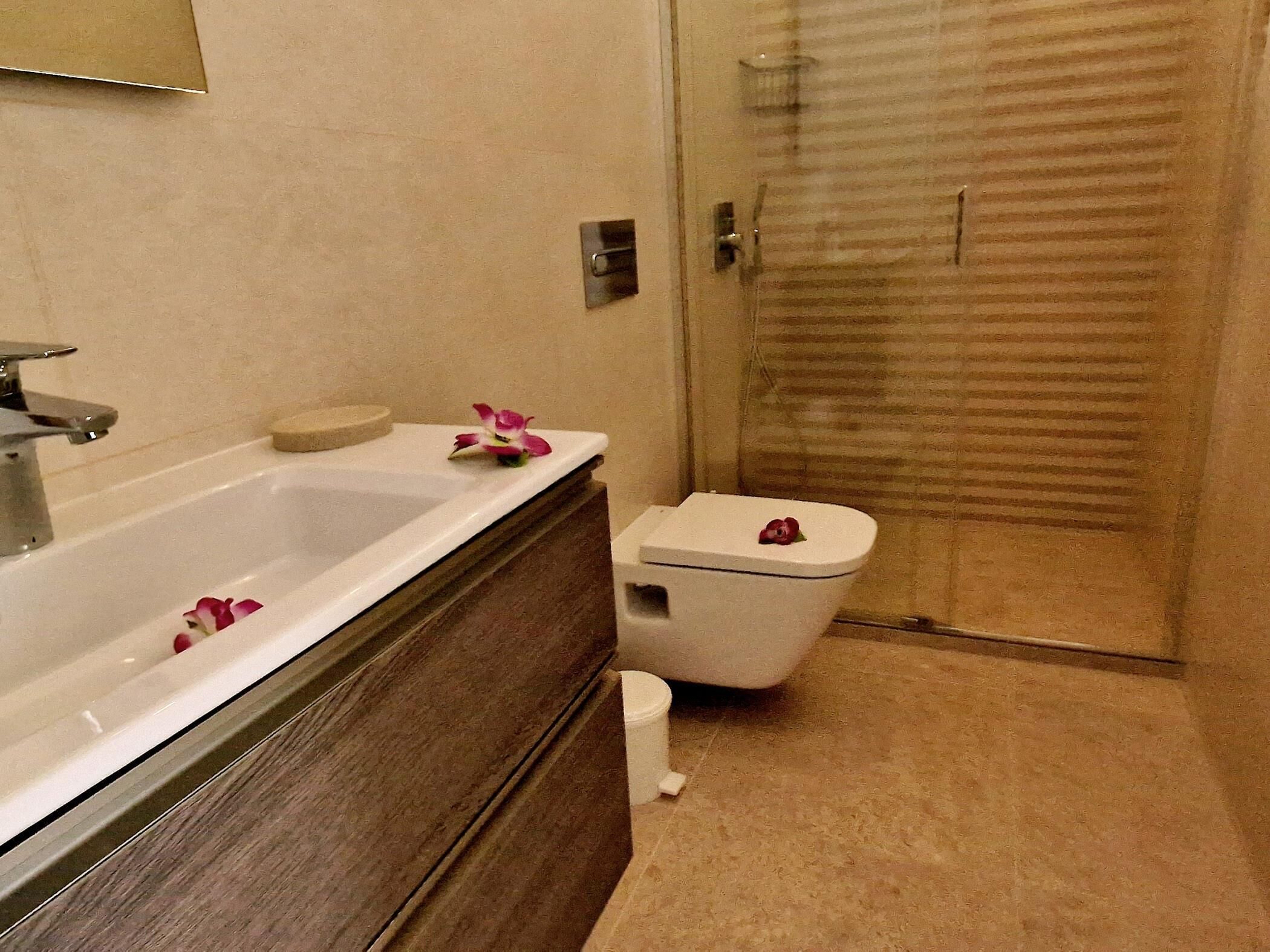 A bathroom with a bathtub, toilet, and shower.